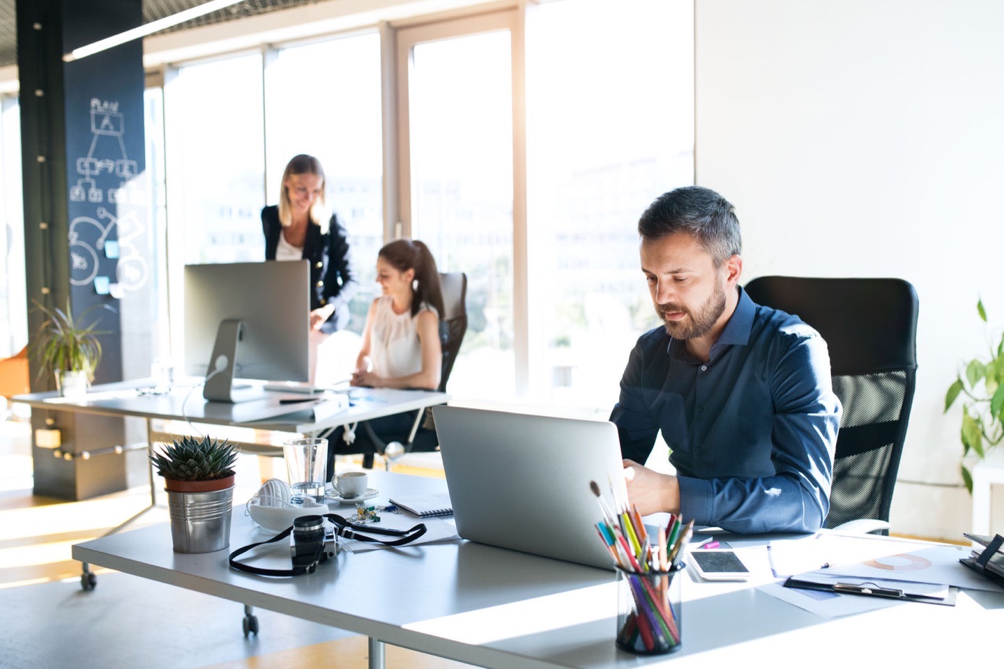A modern office with a team working at their desks