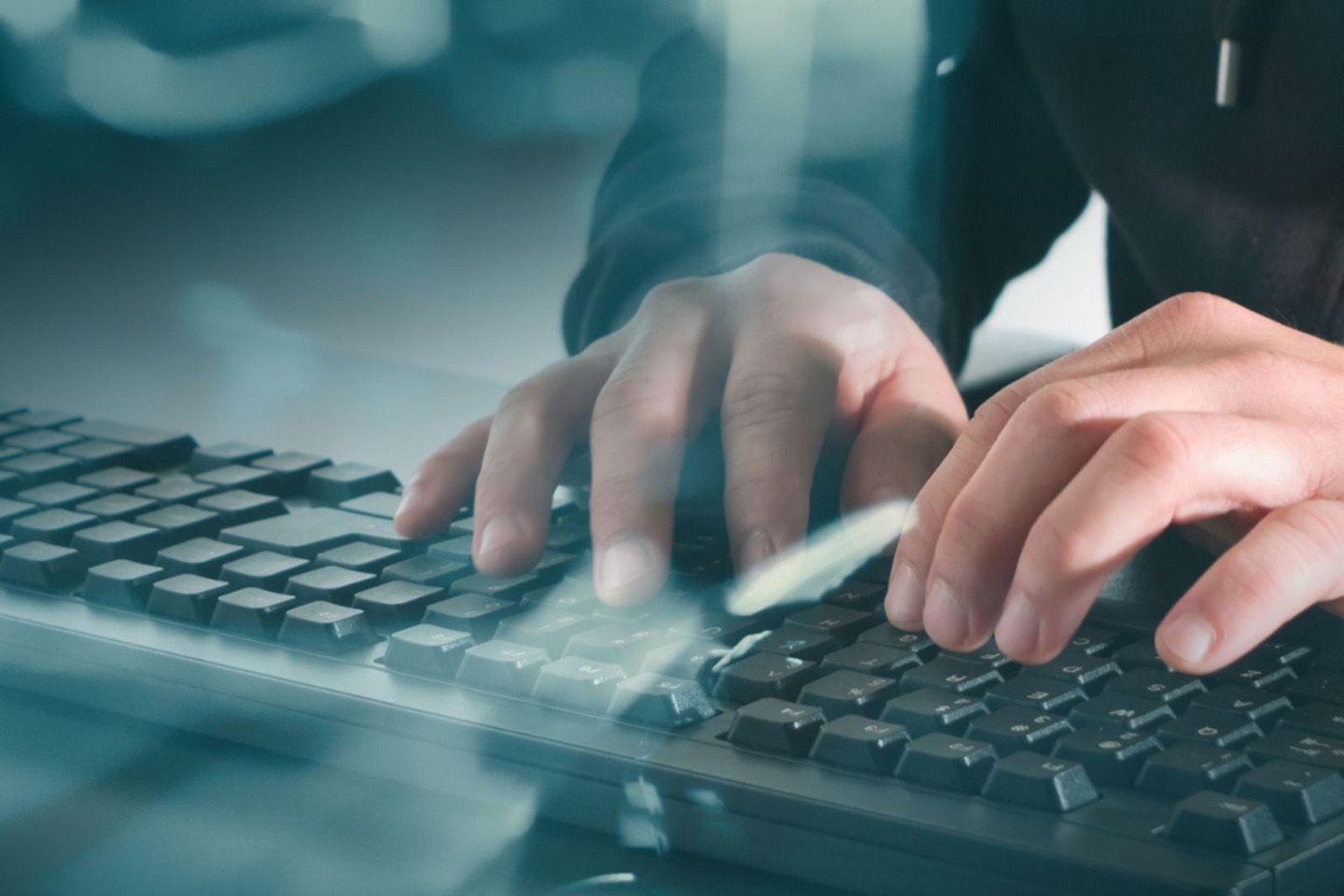 Hands typing on a keyboard